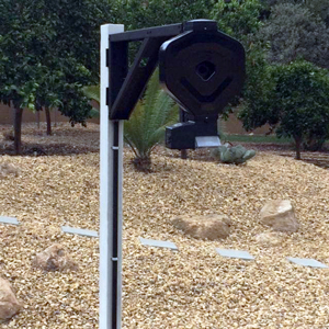 pipe mounted automatic feeder on side of koi pond
